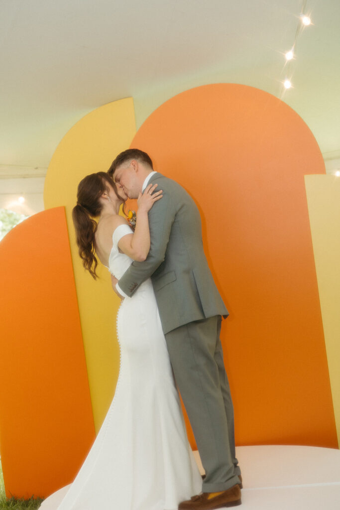 Bride and groom kissing during their backyard Ann Arbor wedding ceremony