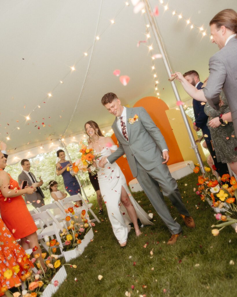 Bride and groom walking back down the aisle after their backyard Ann Arbor wedding ceremony