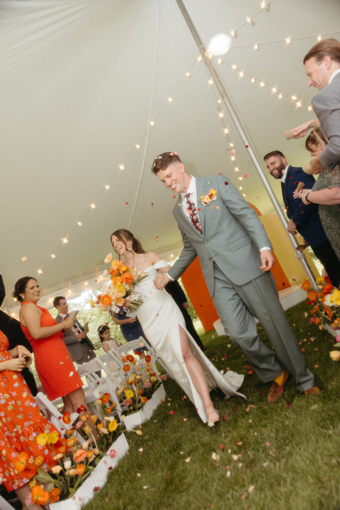 Bride and groom walking back down the aisle as husband and wife after their backyard Ann Arbor wedding ceremony