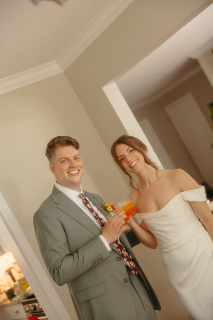 Bride and groom sharing drinks during cocktail hour