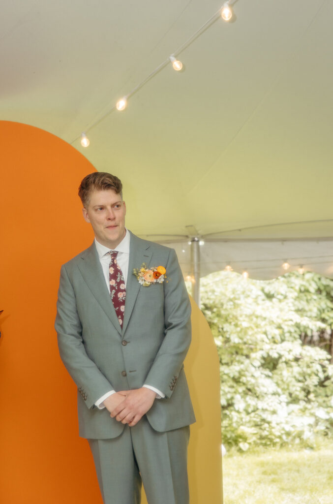 Groom getting emotional as he sees his bride walking down the aisle