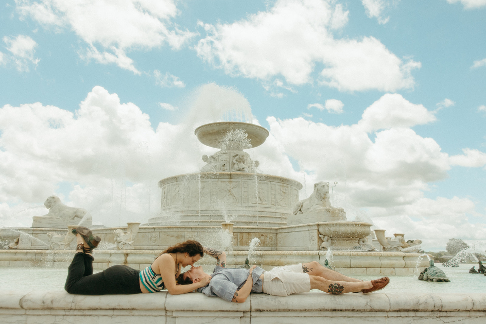 Couple posing at the water fountain for their Belle Isle engagement photos in Detroit