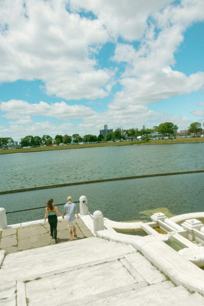 Couple walking down some stairs for their Belle Isle engagement photos