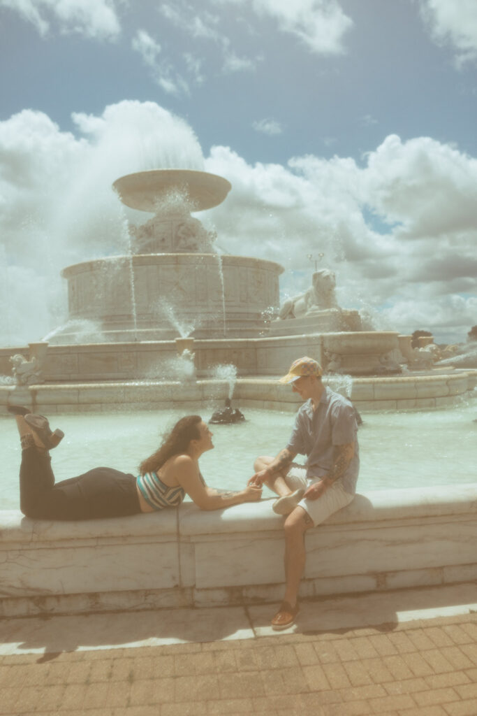 Couple hanging out at the water fountain in Belle Isle