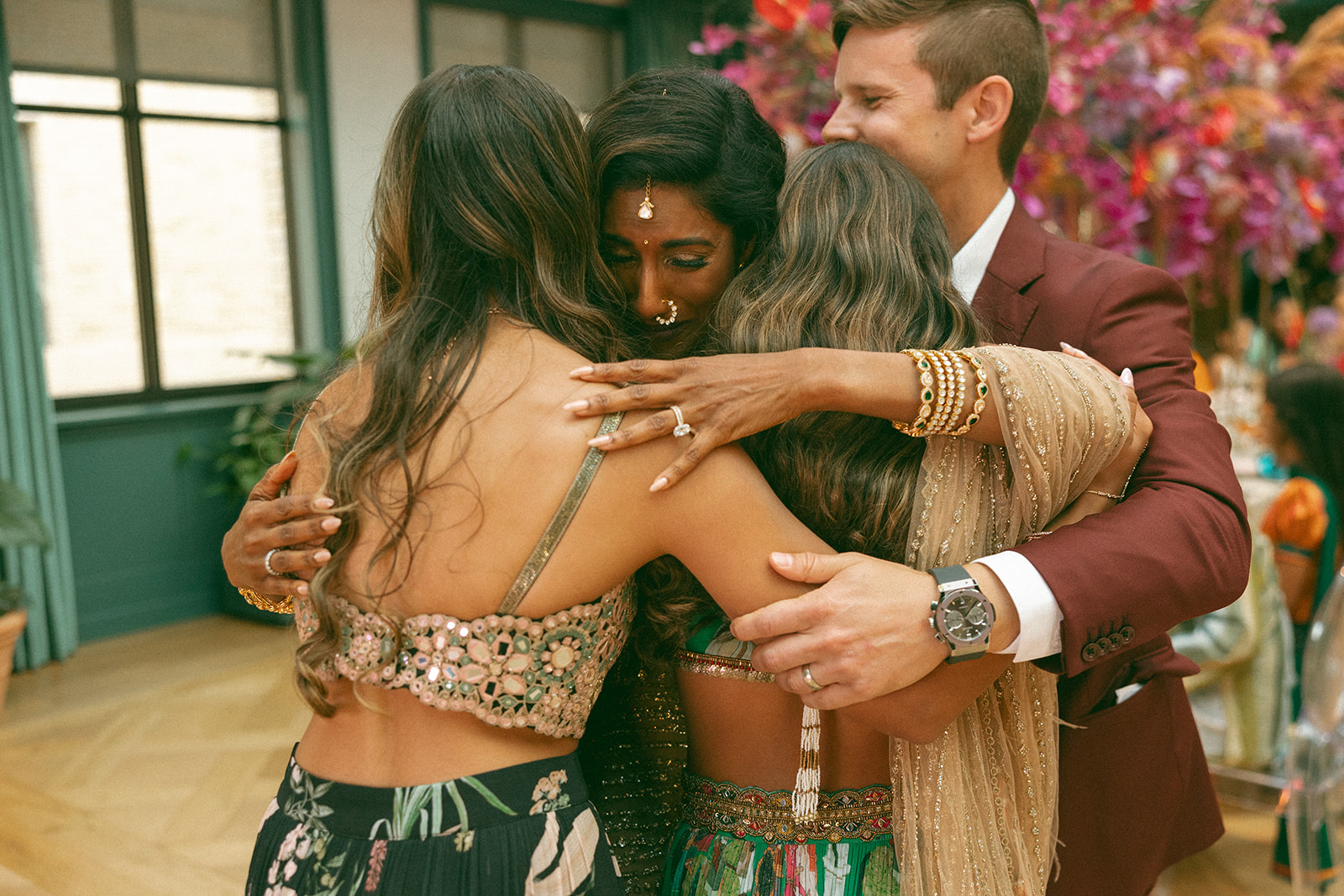 Couple hugging their children after they gave a speech at their anniversary dinner