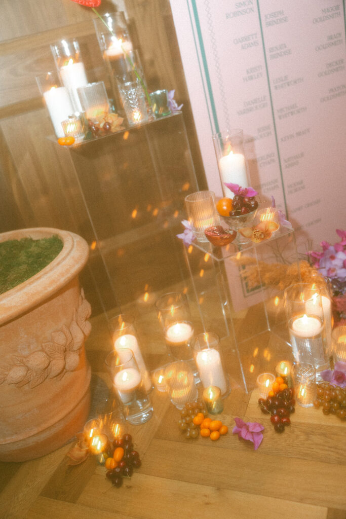 Lit candles with fruit decor