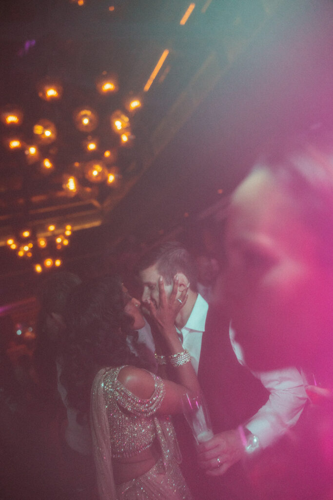 Couple kissing during their Book Tower wedding anniversary party in Detroit, Michigan