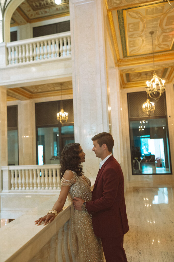 Couple posing for their Book Tower wedding anniversary portraits in Detroit, Michigan 