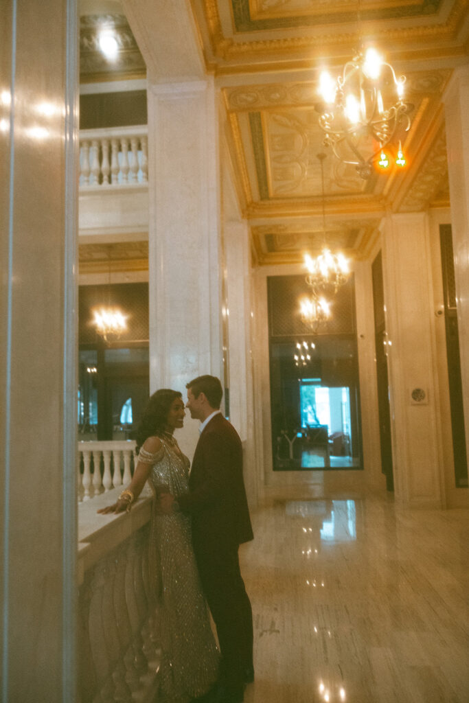 Couple posing for their Book Tower wedding anniversary portraits in Detroit, Michigan 