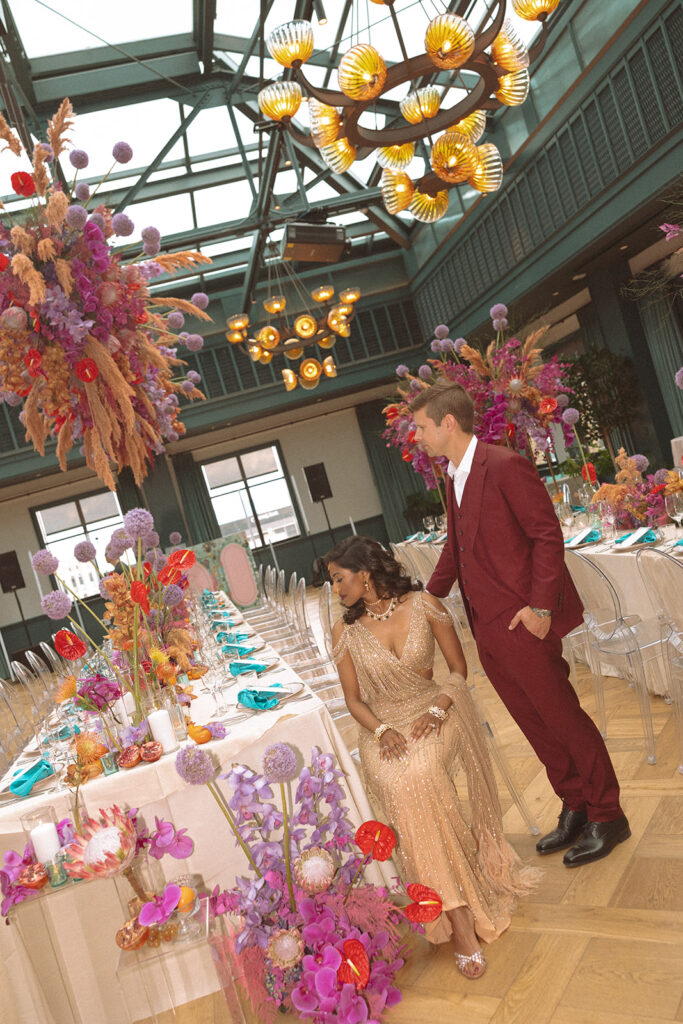 Couple posing for their Book Tower wedding anniversary portraits in the Conservatory Ballroom 