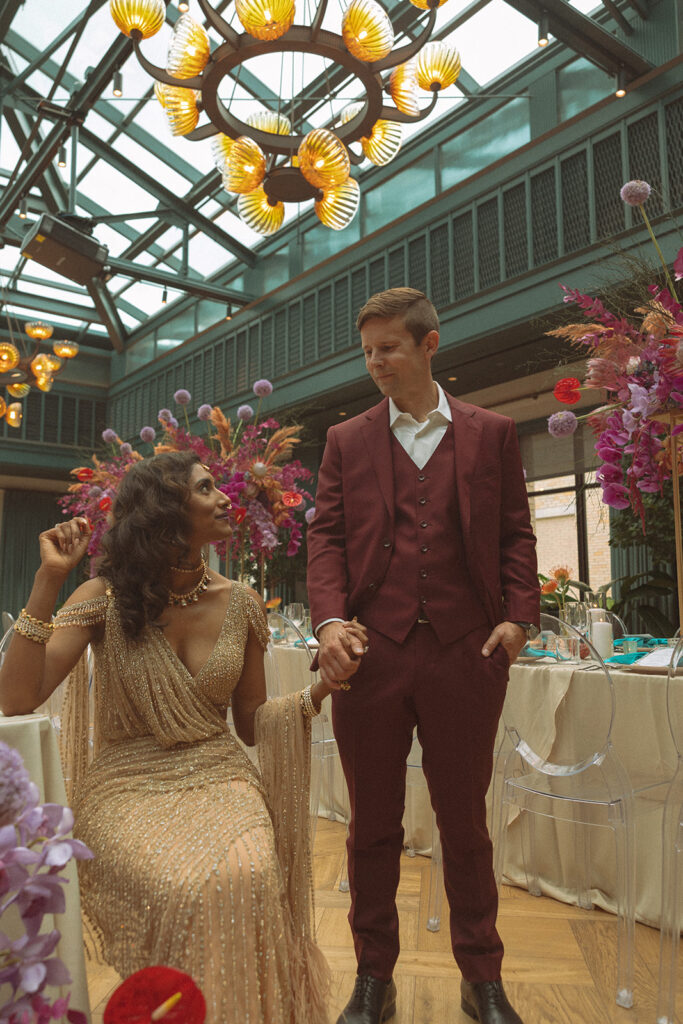 Couple posing for their Book Tower wedding anniversary portraits in the Conservatory Ballroom 