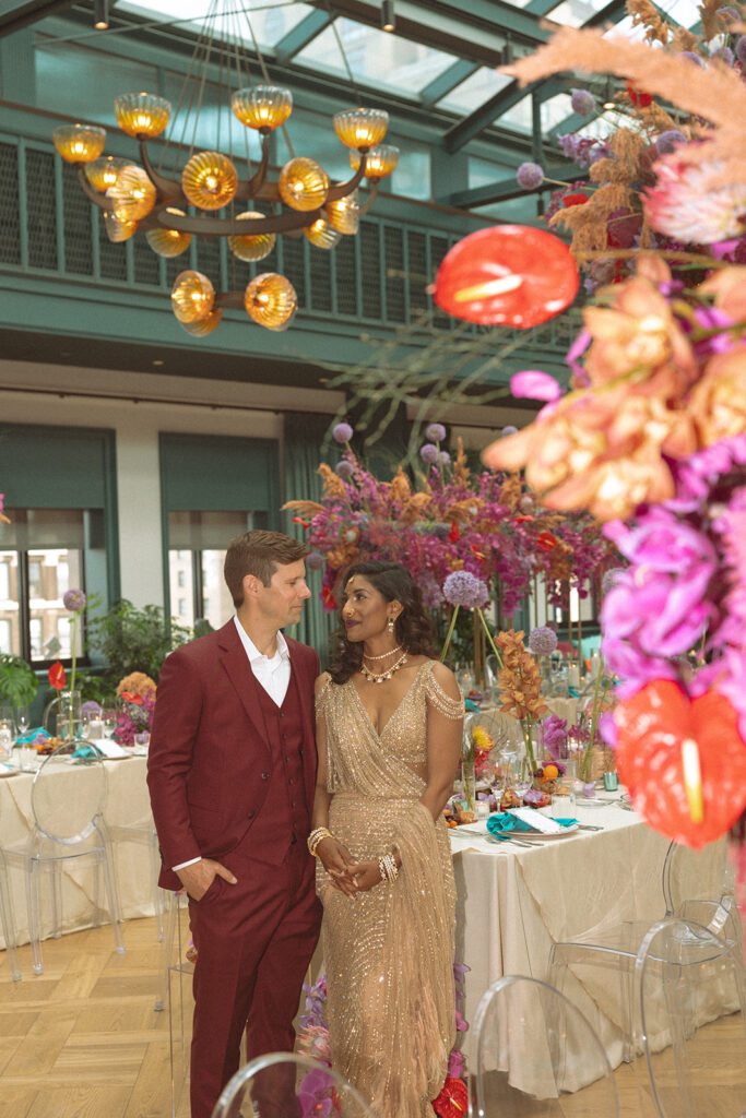 Couple posing for their Book Tower wedding anniversary portraits in the Conservatory Ballroom 