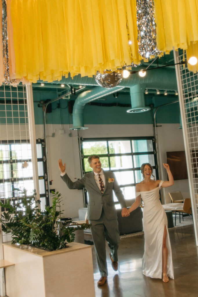 Bride and groom entering their Ann Arbor wedding reception at Venue by 4M