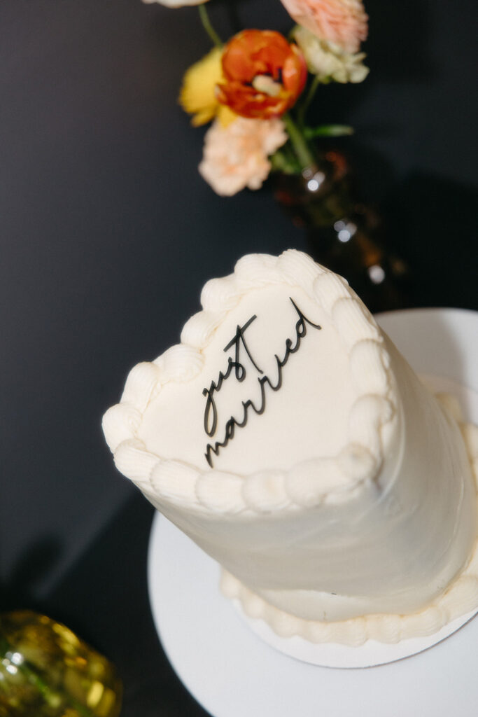 Small white heart shaped cake that says just married