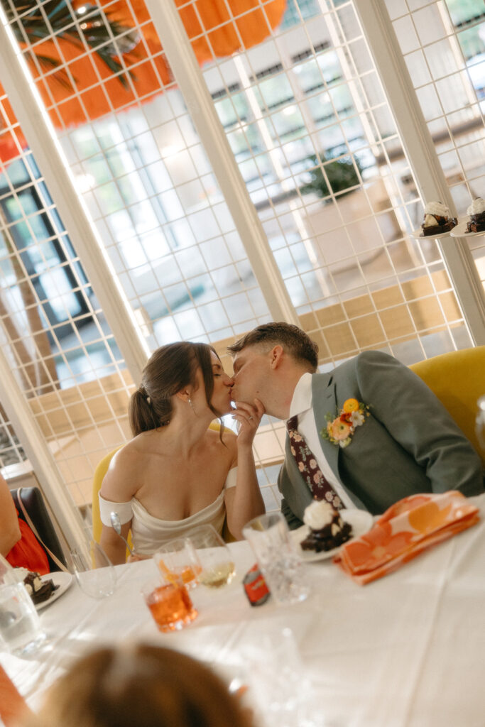 Bride and groom kissing during the reception