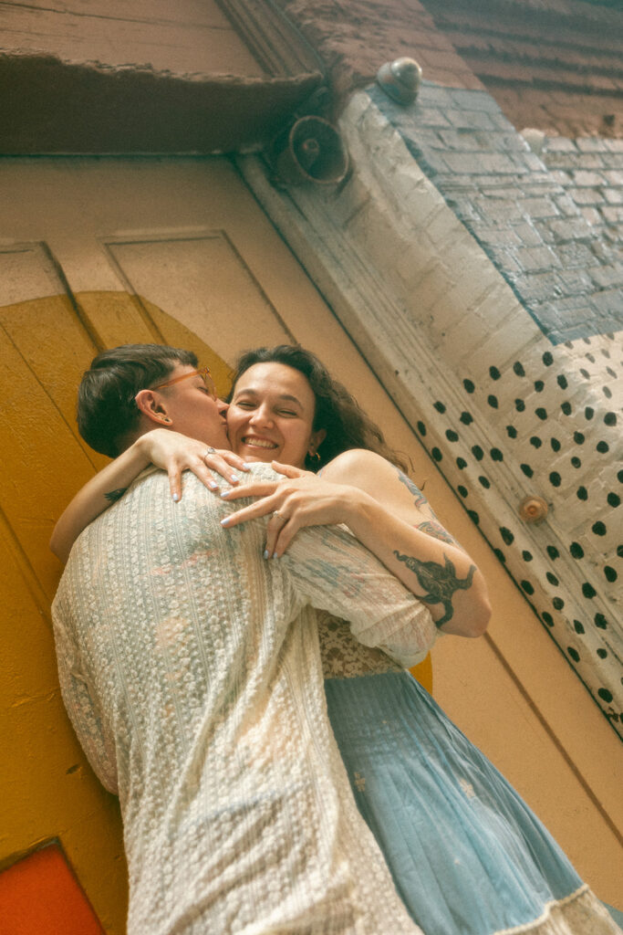 Couple hugging during their colorful engagement session