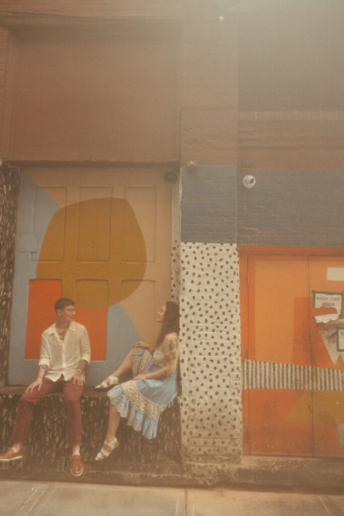 Couple posing for their Detroit engagement session in The Belt Alley in downtown Detroit