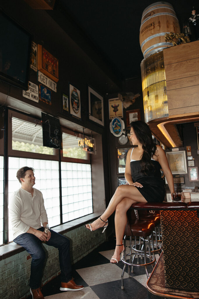 Couple sitting at a bar during their engagement shoot