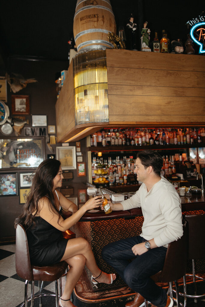 Couple toasting their drinks at Best Intentions Bar in Chicago