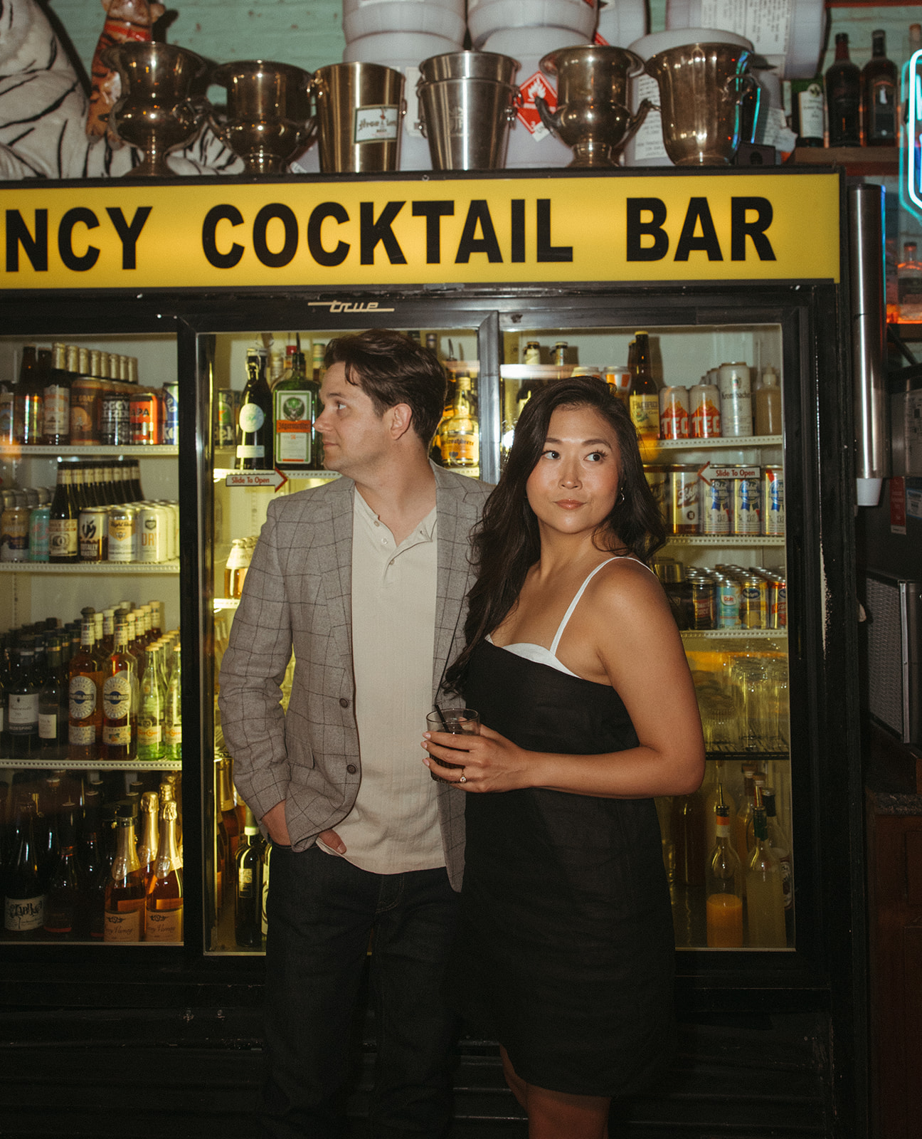 Couple posing for photos at Best Intentions Bar in Chicago