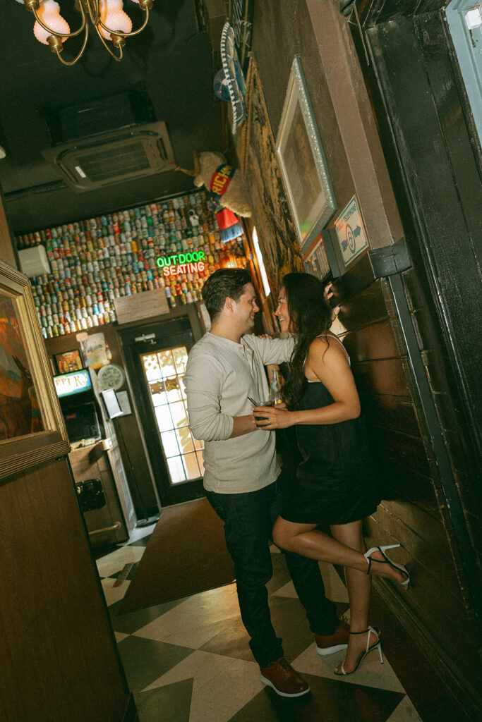 Couple posing at Best Intentions Bar for their engagement shoot