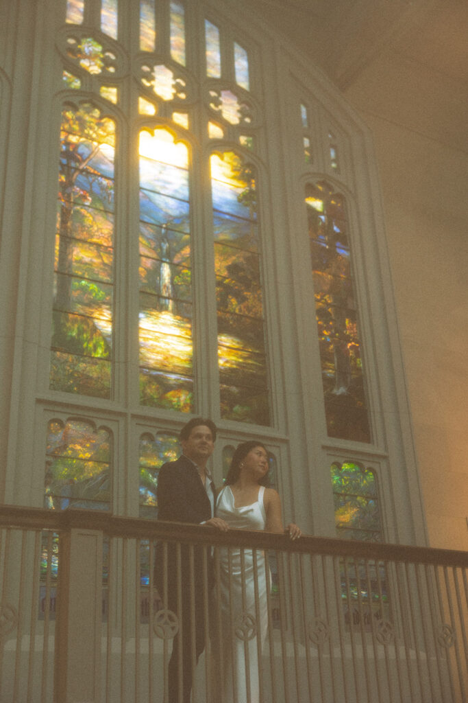 Couple posing on the grand staircase for their Chicago engagement photos at the Art Institute of Chicago