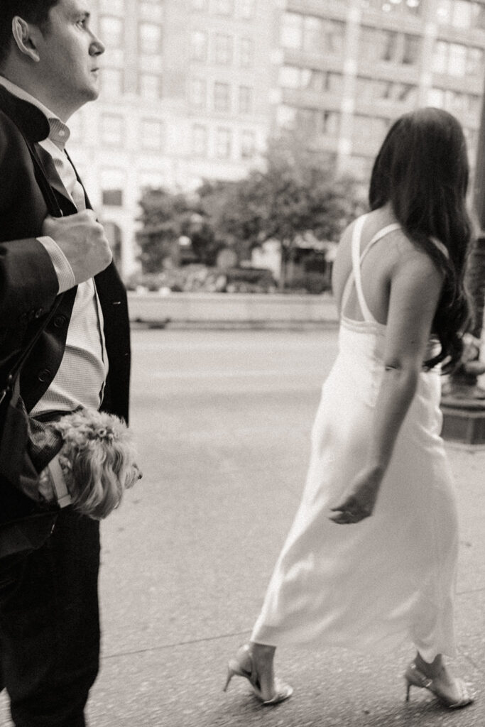 Black and white photo of a couple walking in downtown Chicago