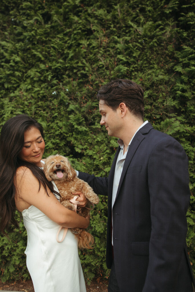 Couple holding their dog