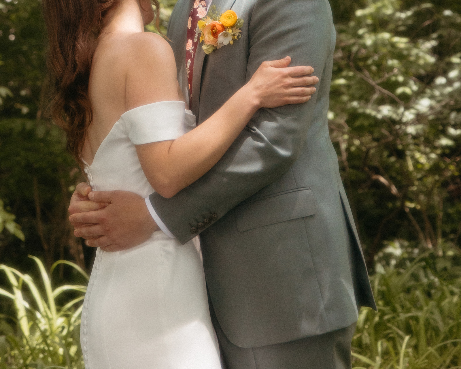 Close up shot of a bride and groom hugging during their first look