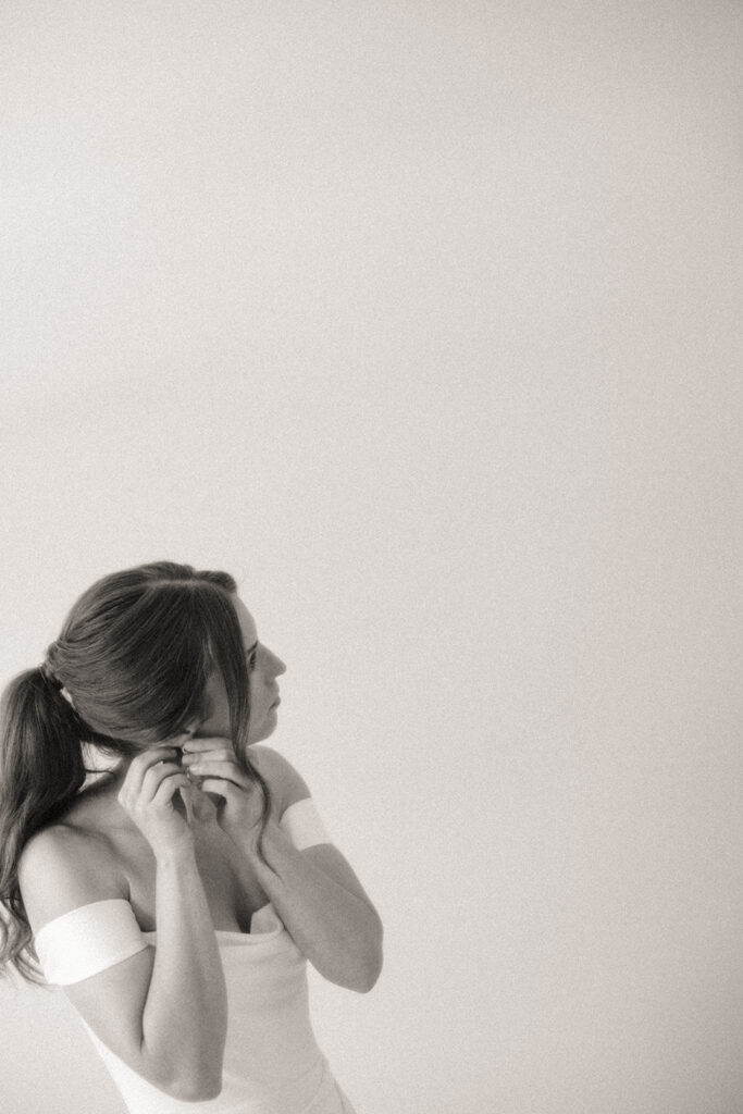 Black and white photo of a bride getting ready