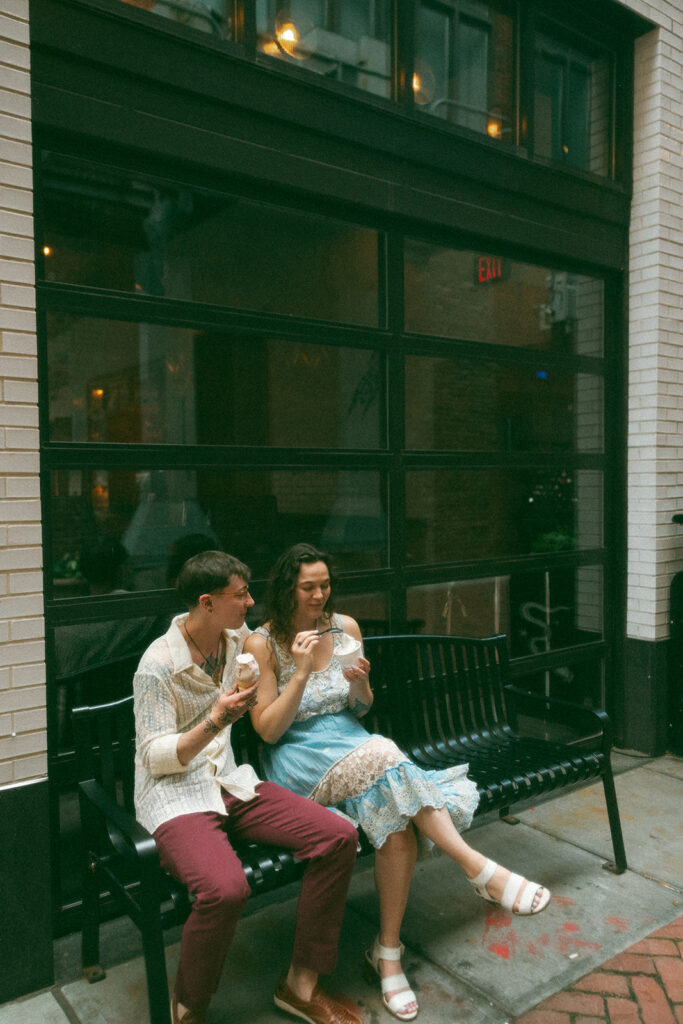 Couple sitting on a bench and eating ice cream from Huddle Ice Cream in Detroit, Michigan