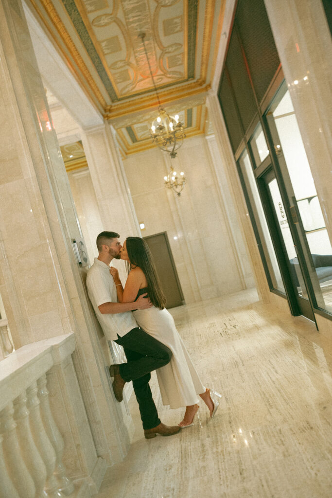 Couple kissing during their Book Tower engagement shoot