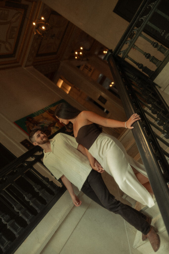 Couple walking down the stairs at Book Tower in Detroit, Michigan