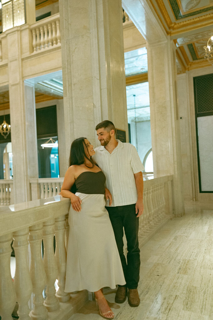 Man and woman looking at each other during their Book Tower engagement