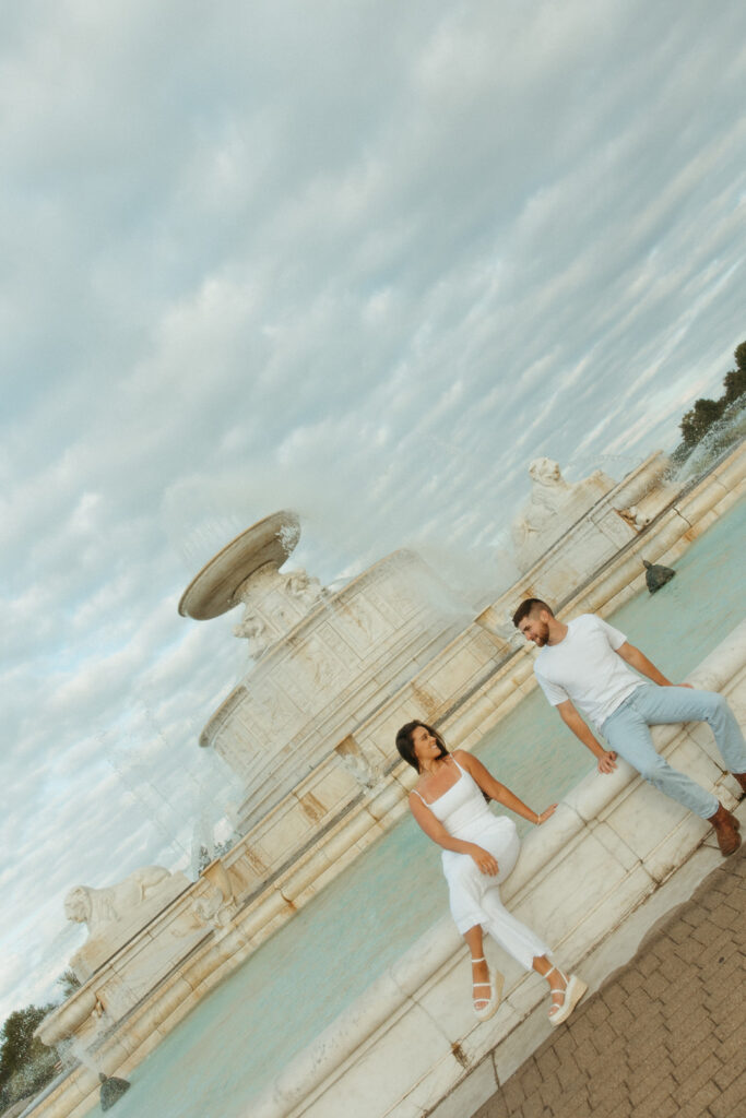 Couple sitting at the tower at Belle Isle for their downtown Detroit engagement photos