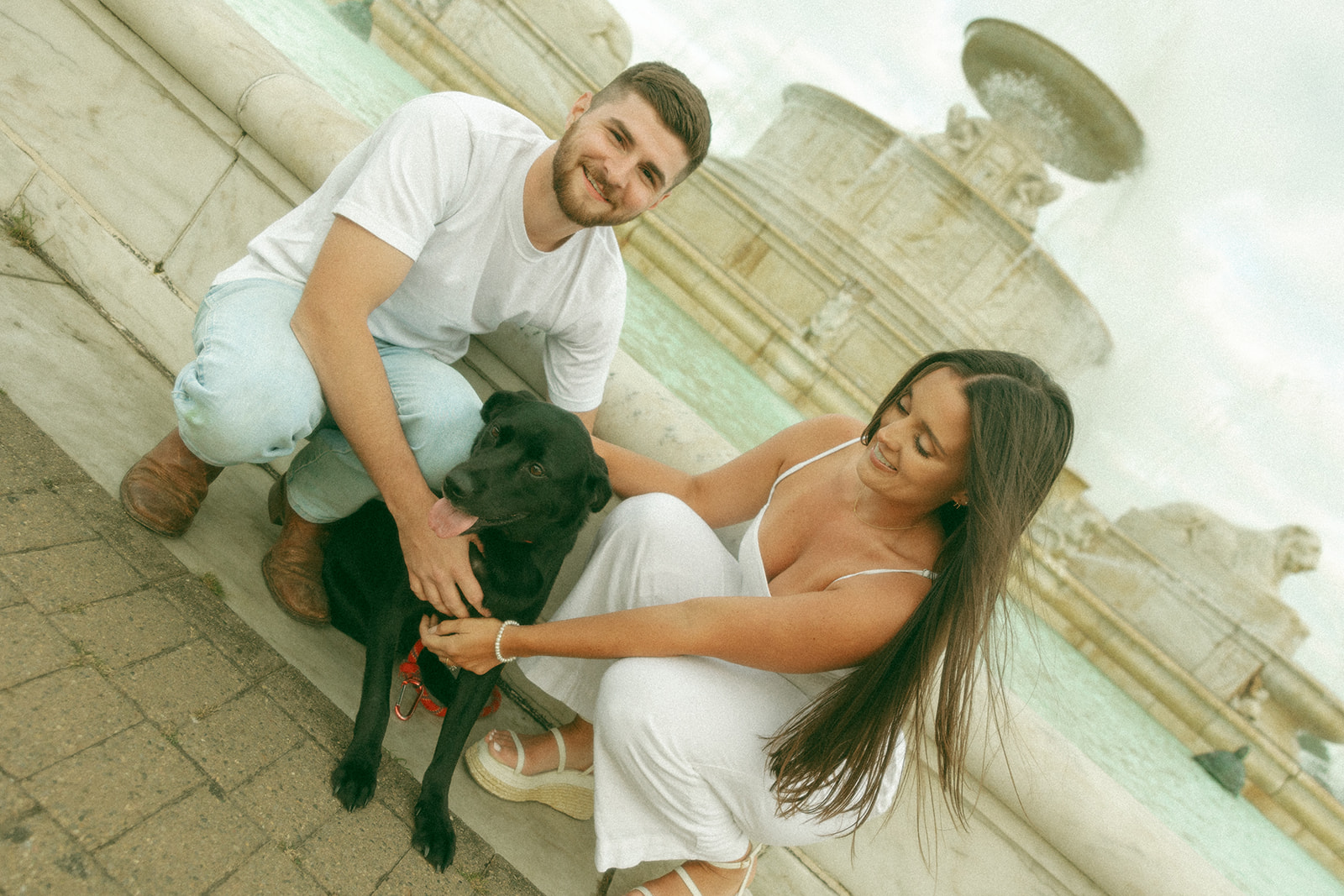 Couple posing with their dog at Belle Isle for their downtown engagement photos in Detroit, MI