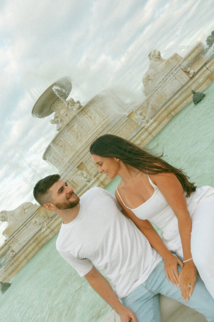 Couple sitting at the tower at Belle Isle for their downtown Detroit engagement photos