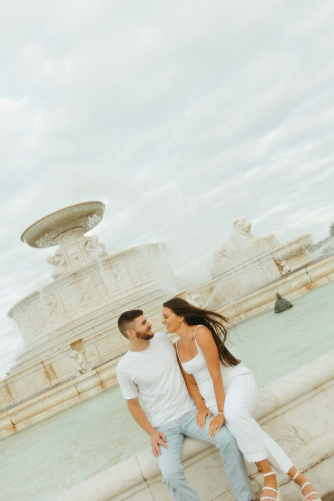 Couple sitting at the tower at Belle Isle for their downtown Detroit engagement photos