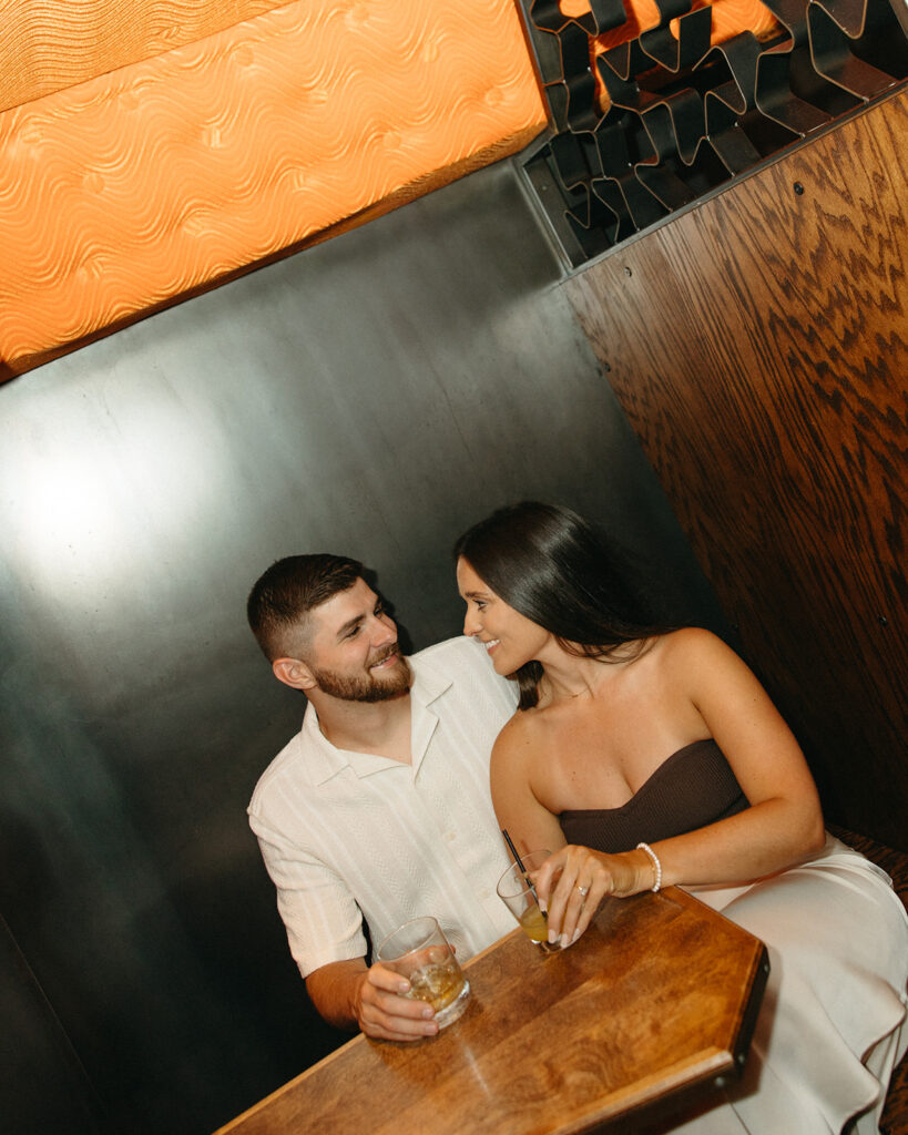 Couple enjoying drinks together during their bar engagement