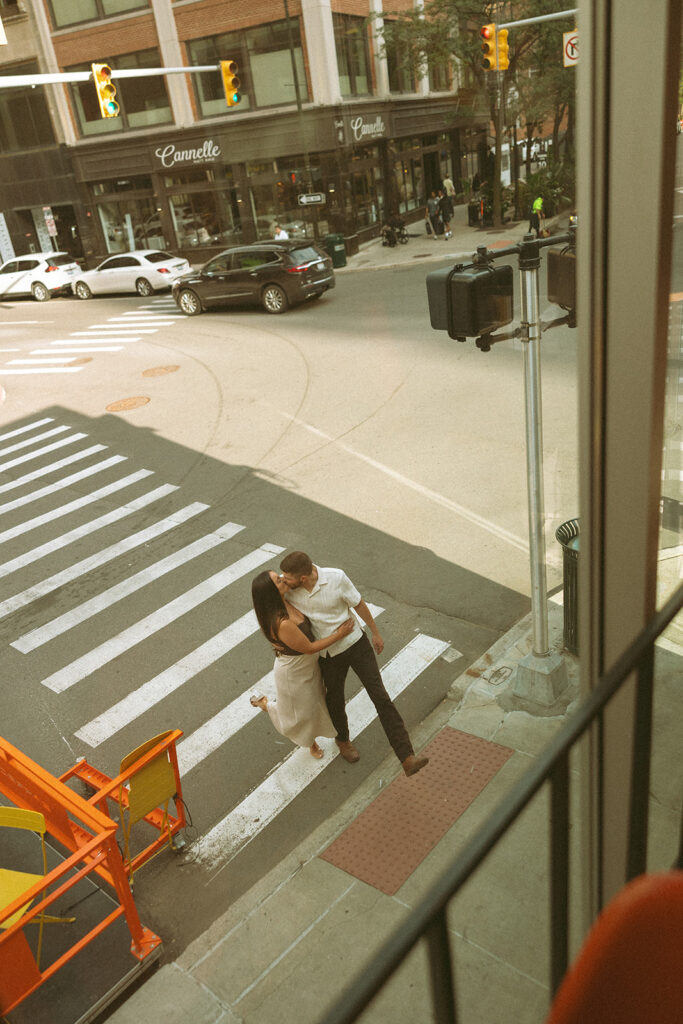 Couple kissing during their downtown engagement photos in Detroit, Michigan