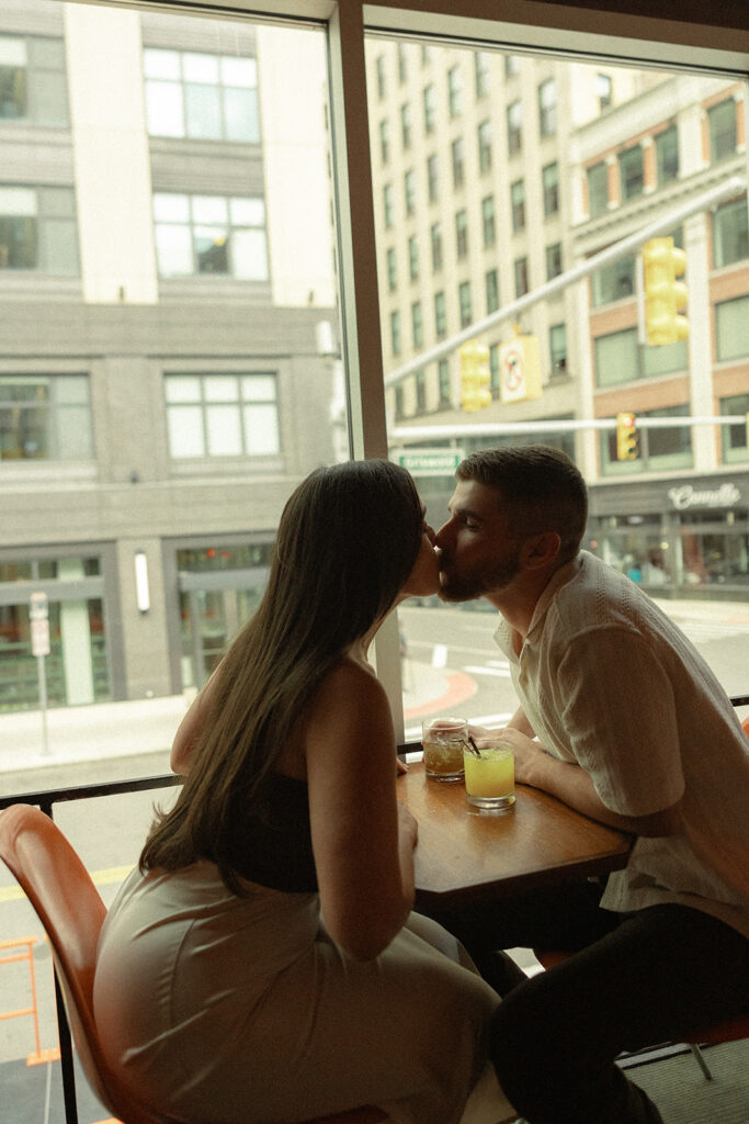 Couple kissing at a bar