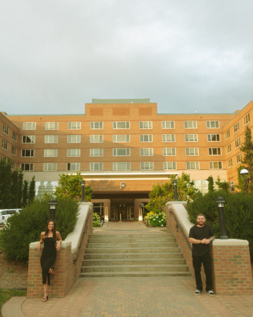 Couple posing in front of The H Hotel in Midland, Michigan