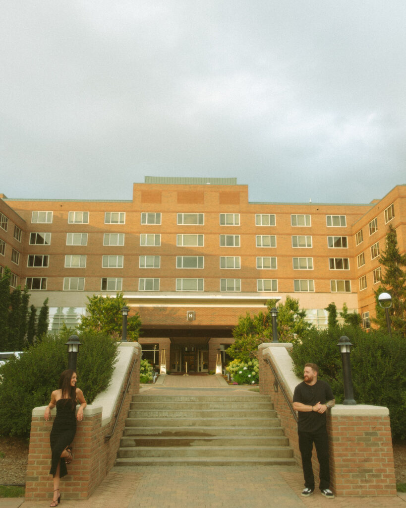 Couple posing in front of The H Hotel in Midland, Michigan