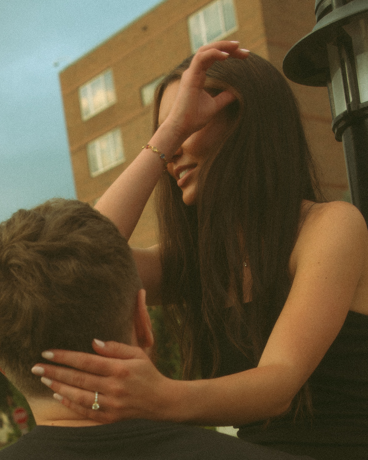 Man and woman posing in Midland for their engagement session