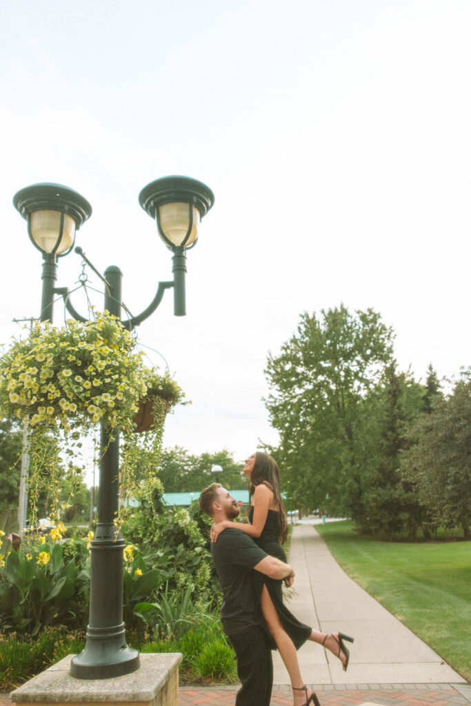 Man picking up his fiancé during their photo session