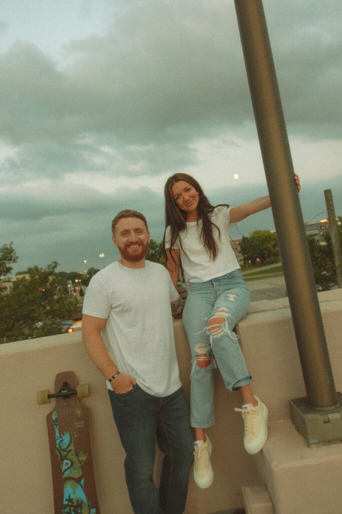 Couple posing on a rooftop parking garage for their Midland engagement photos