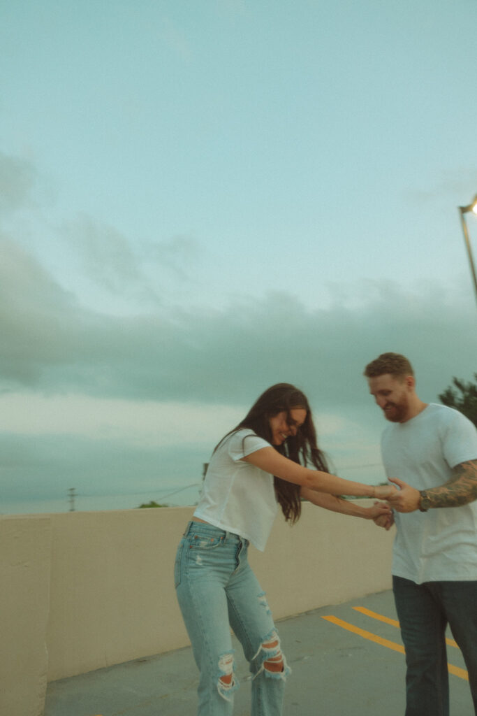 Man helping his fiancé longboard