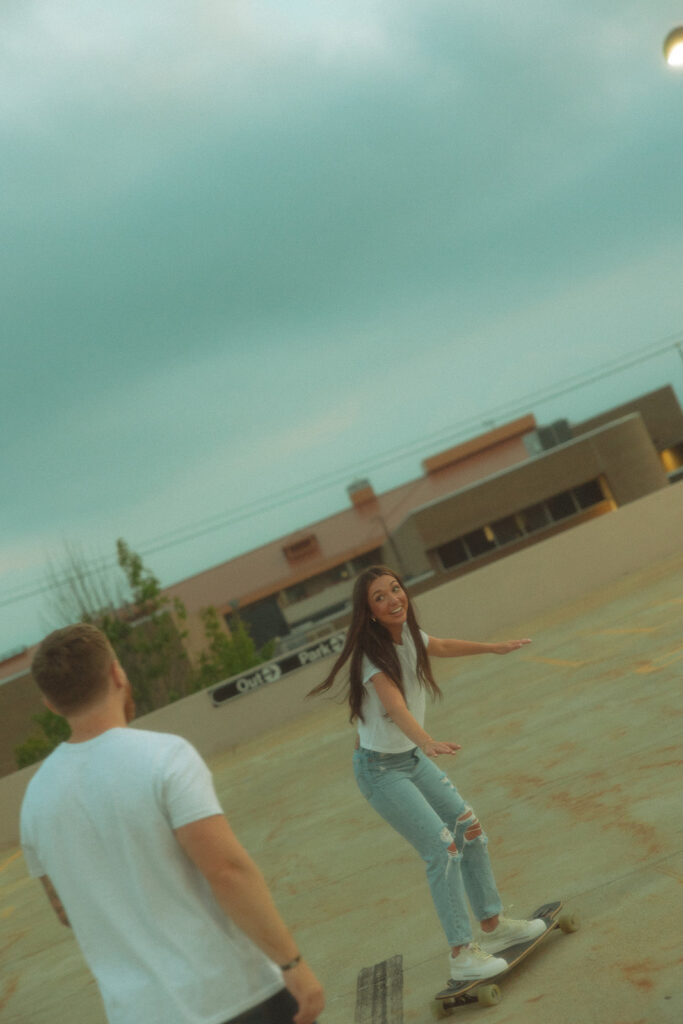 Woman longboarding on a rooftop parking garage