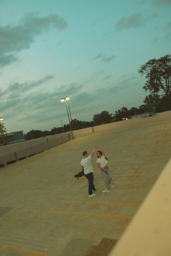 Couple dancing on top of a rooftop parking garage