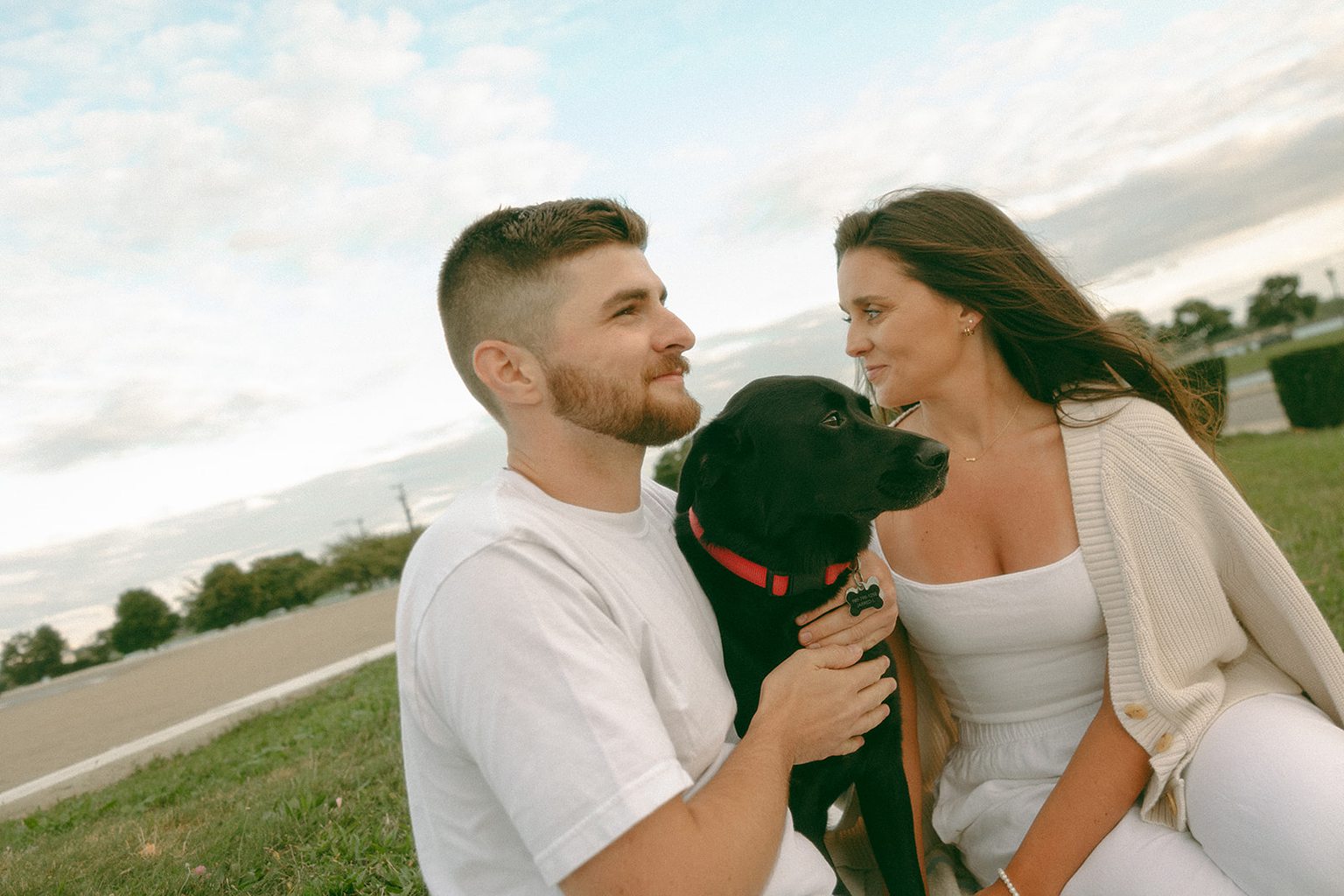 Couple posing with their dog at Belle Isle